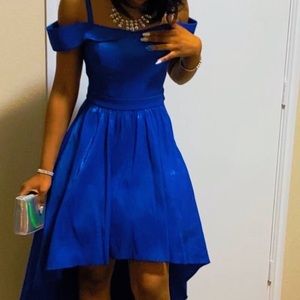 Royal blue prom dress with spaghetti straps and a train in the back.